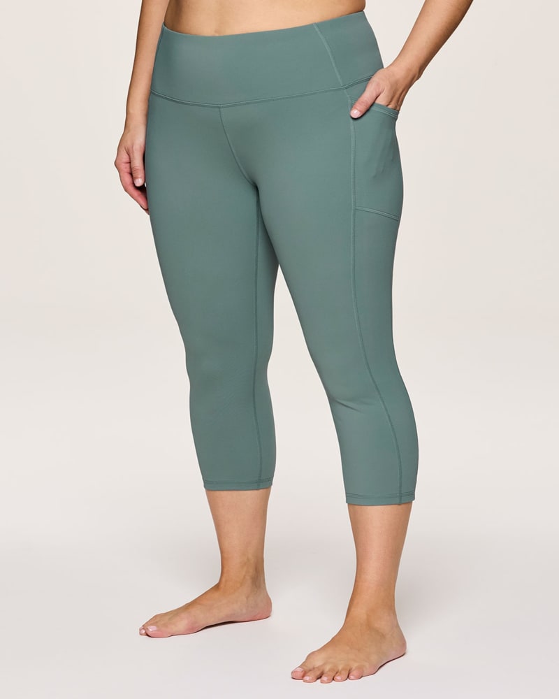 Front of a model wearing a size 1X Plus Tech Flex Ultra Hold Capri in Sea Green by RBX Active. | dia_product_style_image_id:347024